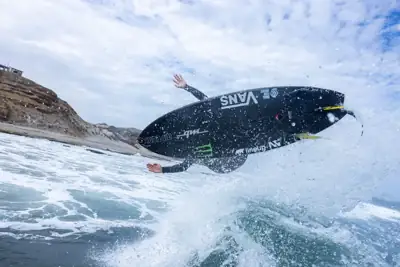 Bodyboarder and board airborne above white water after a wave